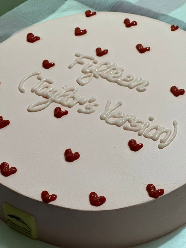 a white cake with red hearts on it