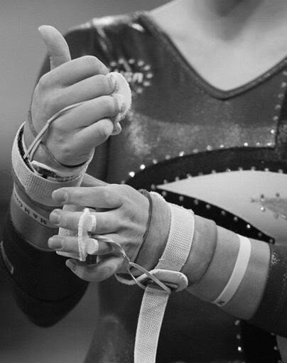 black and white photograph of woman holding something in her hand with string attached to it