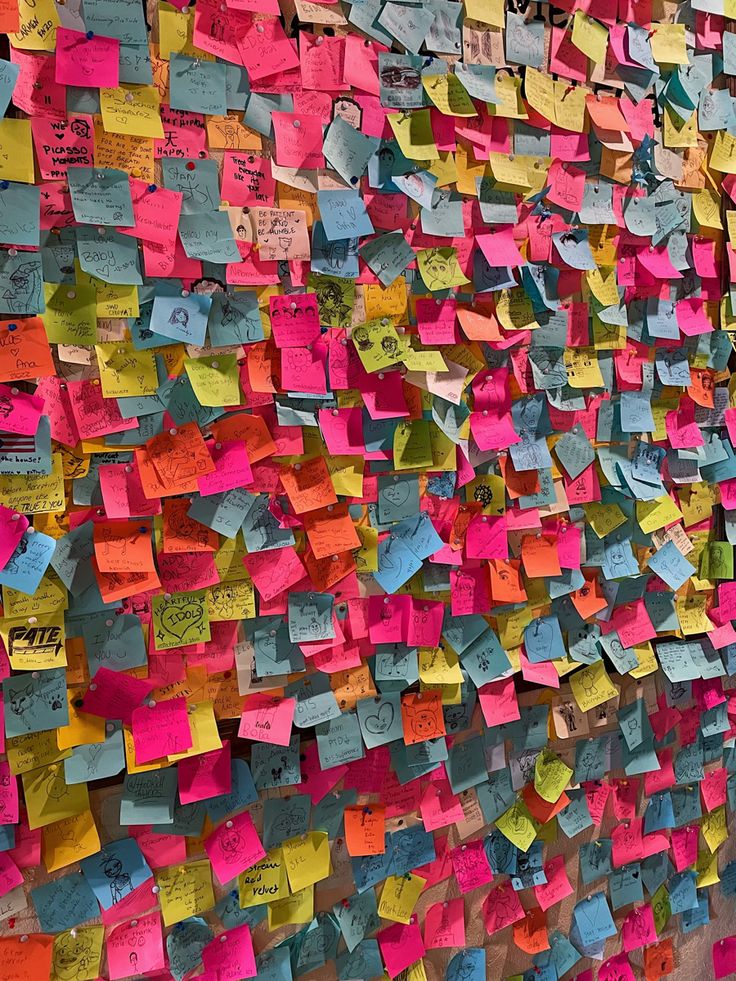 a wall covered in lots of colorful sticky notes