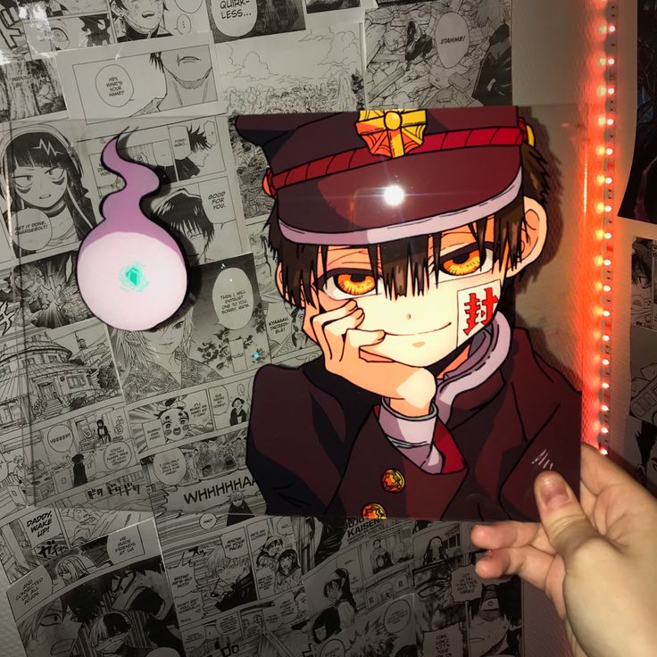 a person holding up a poster with an anime character on it