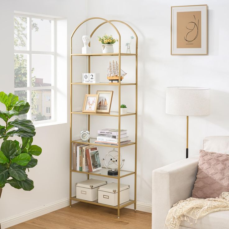 a living room filled with furniture and a potted plant on top of a shelf