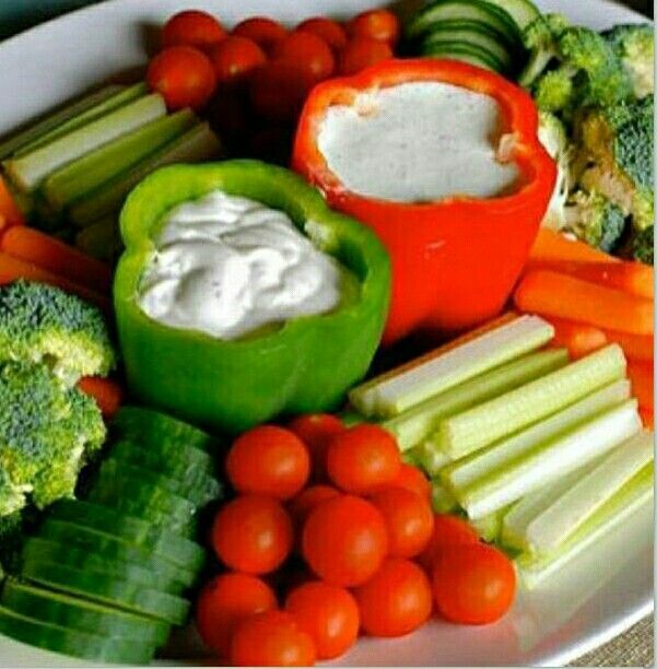 a white plate topped with veggies and dip