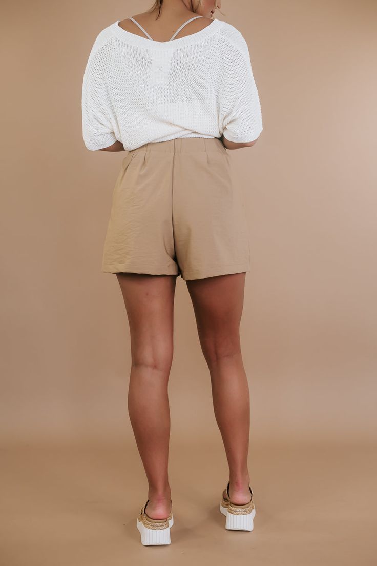 Our Prim & Proper Pleated Short features a high-waisted fit and a flattering button fly detail. The functional side pockets and pleated detailing create a timeless piece that adds a classic boho element to your wardrobe. Waist: High Rise Button fly design Pleated detail Lined Functional side pockets Imported Fabric: 47% Polyester, 39% Rayon, 11% Nylon, 3% Spandex; Lining: 100% Polyester Fit: True to size! MEASUREMENTS: S: INSEAM: 3” | RISE: 12.5” | WAIST: 13” | HIPS: 22”M: INSEAM: 3.5” | RISE: 13” | WAIST 14” | HIPS: 23”L: INSEAM: 4” | RISE: 13.5” | WAIST: 15” | HIPS: 24” Model Specs: Emily is wearing a size small in the photo. How will this item fit you? Check out our MODEL SPECS (Typical Sizing - Karli: S-Size 5/26 - 5ft 2in, Emily: S-Size 3/25 - 5ft 5in, Syd: L/XL- Size 15/ - 5ft 8in)Ne Beige Relaxed Fit Bottoms For Day Out, Relaxed Fit Beige Bottoms For Day Out, Trendy Beige Shorts For Workwear, Trendy Beige Workwear Shorts, Beige Relaxed Fit Shorts For Fall, Brown Bottoms With Button Closure For Spring, Classic Neutral Bottoms With Pockets, Fitted Brown Shorts For Workwear, Relaxed Fit High-waisted Shorts For Work