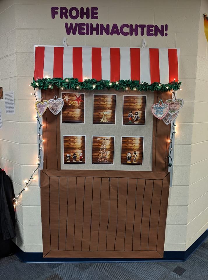 a booth with pictures on the wall and lights strung from it's awnings