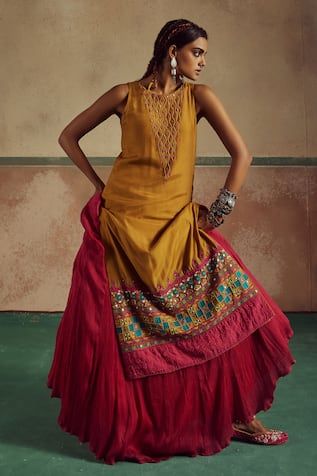 Mustard yellow sleeveless kurta with mirror waves embroidery on the yoke and flora art embroidery on the hem. Paired with contrasting pink crushed cotton silk lehenga and contrasting border mirror work dupatta.
Components: 3
Pattern: Embroidery
Type Of Work: Threadwork, Mirror
Neckline: Round
Sleeve Type: Sleeveless
Fabric: Kurta: Bamberg Silk, Lehenga: Crushed Cotton Silk, Dupatta: Bamberg Silk
Color: Yellow
Other Details: 
Length:
Kurta: 48 inches
Lehenga: 44 inches
Note: The accessories worn Yellow Sleeveless Set For Eid, Fitted Yellow Dress For Transitional Season, Sleeveless Fitted Kurta With Pallu, Yellow Sleeveless Designer Wear Sets, Festive Yellow Sleeveless Kurta, Traditional Yellow Sleeveless Sharara, Yellow Mirror Work Sets In Dola Silk, Yellow Sleeveless Set With Dupatta, Yellow Dola Silk Lehenga With Mirror Work