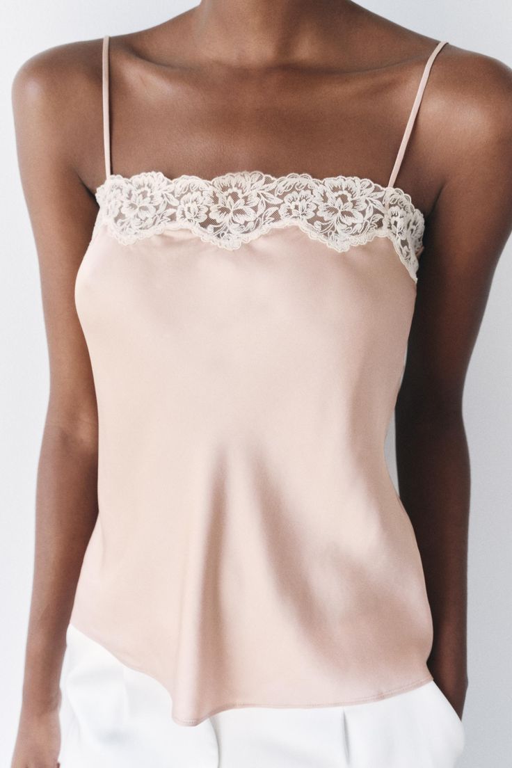 Chic Delicate Lace Tank Top For Spring, Feminine Tank Top With Spaghetti Straps And Built-in Bra, Feminine Tank Top With Built-in Bra, Cami Top With Built-in Bra For Evening, Chic Tops With Lace Bodice For Night Out, Chic Lace Bodice Top For Night Out, Lace Top With Lace Bodice For Night Out, Feminine Sleeveless Camisole With Adjustable Straps, Feminine Camisole With Adjustable Straps