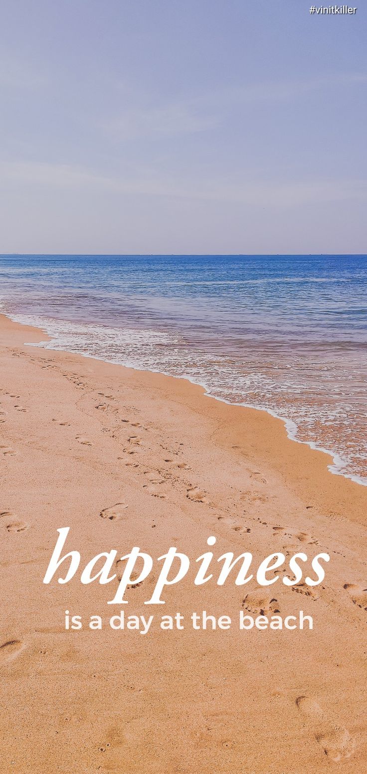 a beach with footprints and the words happiness is a day at the beach