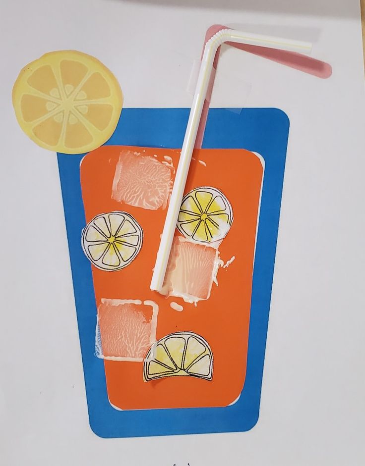 an orange tray with lemons and strawberries on it, next to a paper cutout