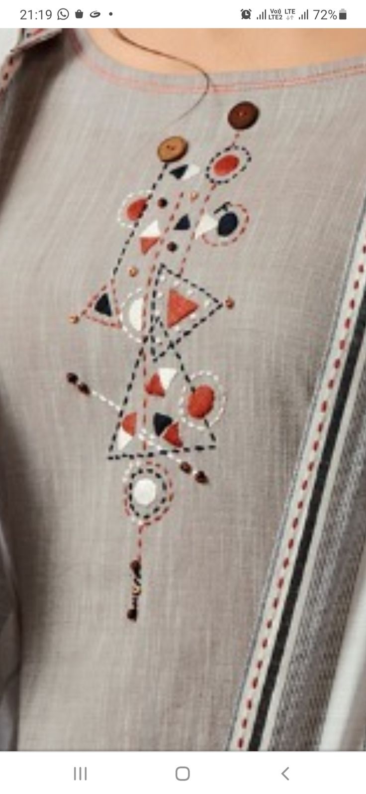 an image of a woman's shirt with buttons and beads on the collarline