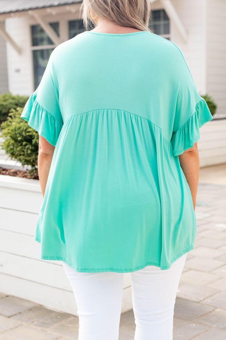 This top is too sweet! It has a flirty and feminine design with a figure-flattering fit you'll want to wear all day long! It's light and flowy and has the cutest ruffled sleeves! Not to mention how easy the solid mint color is to pair with your favorite accessories! Style this top with skinnies and wedges for an effortlessly chic look! 95% Rayon, 5% Spandex Made In USA. Vacation Flutter Sleeve Top With Ruffle Hem, Vacation Tops With Ruffle Hem And Flutter Sleeves, Flutter Sleeve Tops With Ruffle Hem For Vacation, Casual Butterfly Sleeve Tops For Vacation, Casual Tops With Butterfly Sleeves For Vacation, Green Butterfly Sleeve Tops For Spring, Trendy Flutter Sleeve Tops For Vacation, Stretch Ruffle Tops For Vacation, Feminine Flutter Sleeve Top With Ruffle Hem