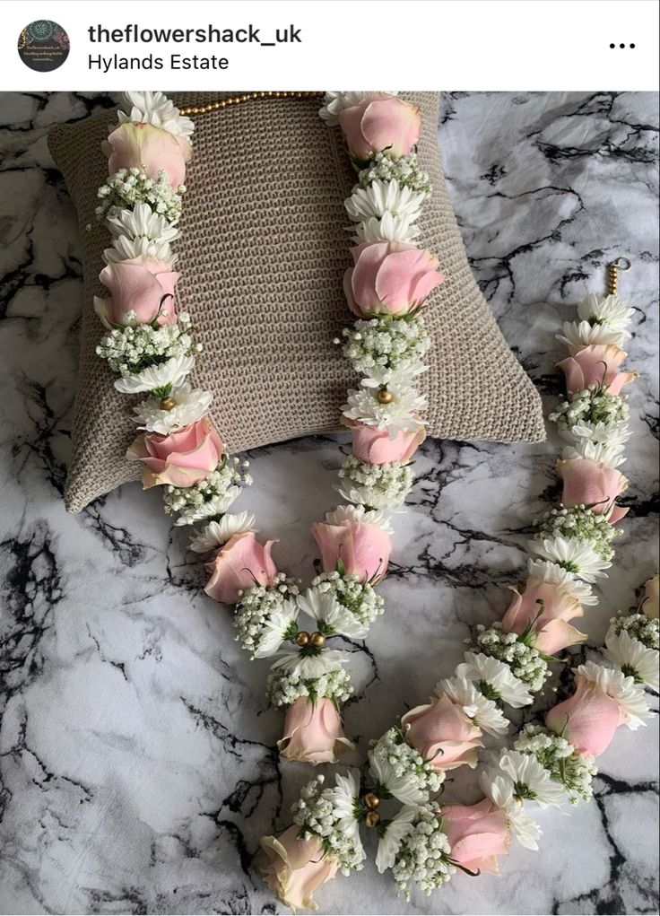 the flowers are arranged on the necklace