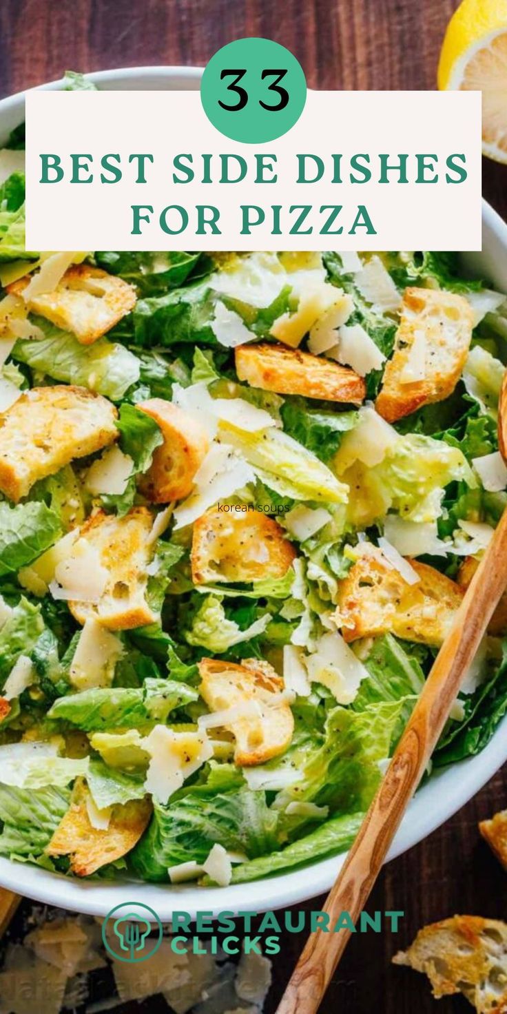 a white bowl filled with salad next to lemon wedges and some breadsticks