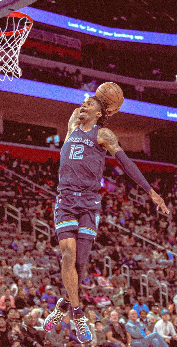 a basketball player jumping up to dunk the ball in front of an arena full of people