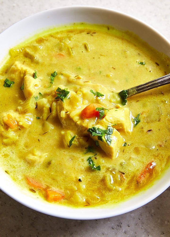 a white bowl filled with soup on top of a table