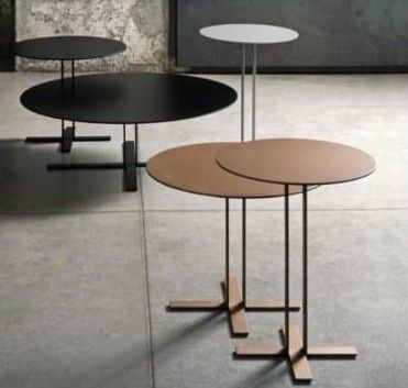 three different tables sitting on top of each other in front of a concrete wall and floor