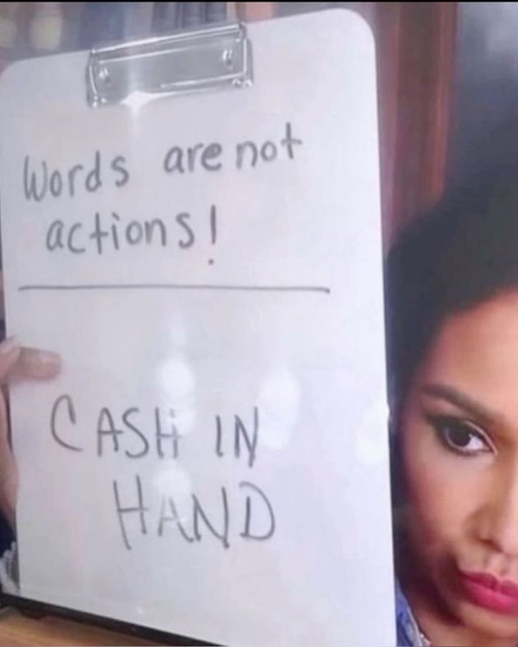 a woman holding up a sign that says words are not actions i cash in hand