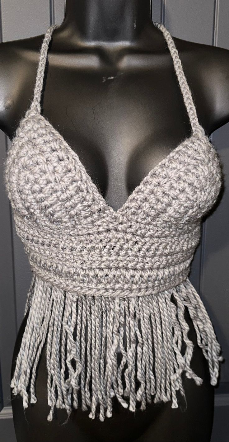 a mannequin wearing a halter top with tassels