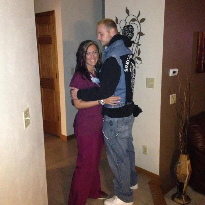 a man and woman are hugging in the middle of a room with tile flooring