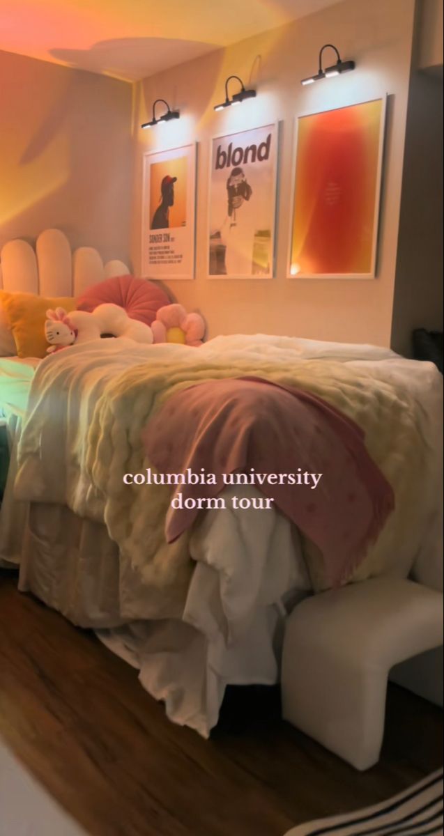 a bed room with a neatly made bed and pictures on the wall