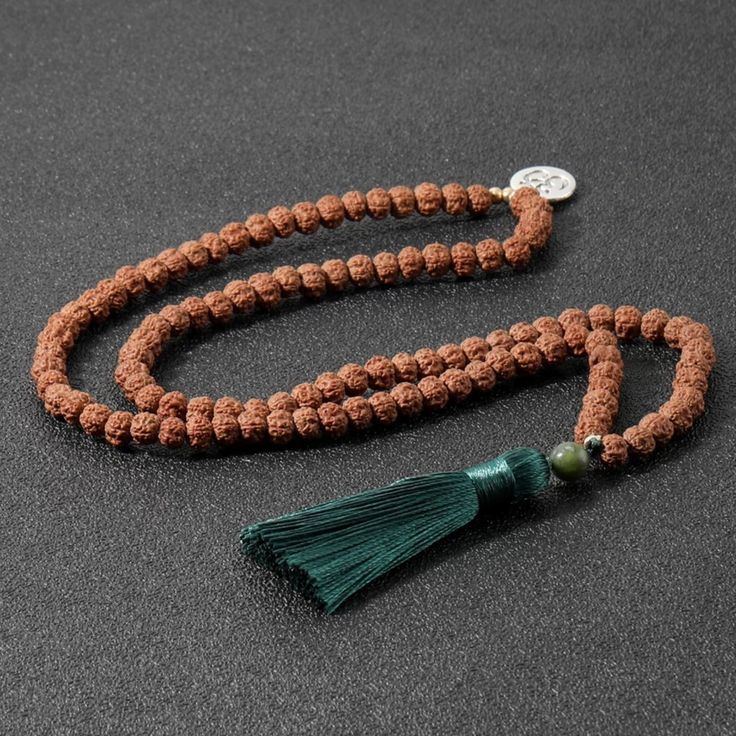 Handcrafted 108 Sacred Rudraksha Seeds With Silk Tassel, Silver Toned Om Charm And Jade Guru Bead Meditation Mala. Will Be Energetically Charged By A Reiki Master The Natural And 100% Sustainable Seed Beads Have Amazing Texture And Visual Appeal. Rudraksha Beads Are Known For Their Healing Properties And Protective Powers. According To Ancient Vedic Texts, Rudraksha Beads Are Endowed With Cosmic Powers To Elevate The Soul And Assist On The Path Of Ascension. By Meditating With A Rudraksha Mala I Spiritual Silver Beads Mala Gift, Silver Mala With 108 Beads As Gift, Silver Mala With Round Beads For Meditation, Silver Mala With 108 Beads For Meditation, Adjustable Silver Mala For Meditation, Adjustable Silver Traditional Mala, Festival Necklaces With 8mm Beads, Adjustable Silver Spiritual Mala, Silver Adjustable Spiritual Mala