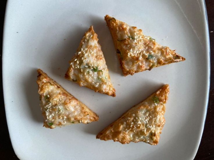 four pieces of food on a white plate