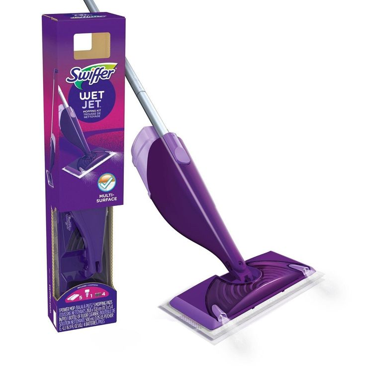 a purple floor sweeper sitting in front of a box