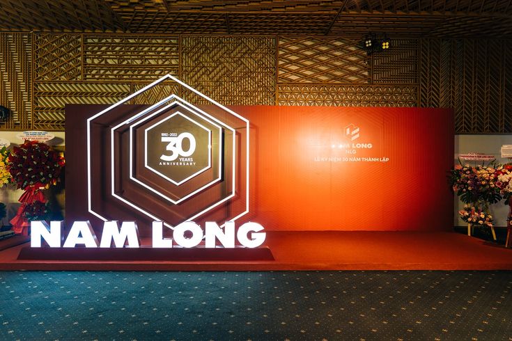 a sign that says nam long on it in front of some red and orange walls