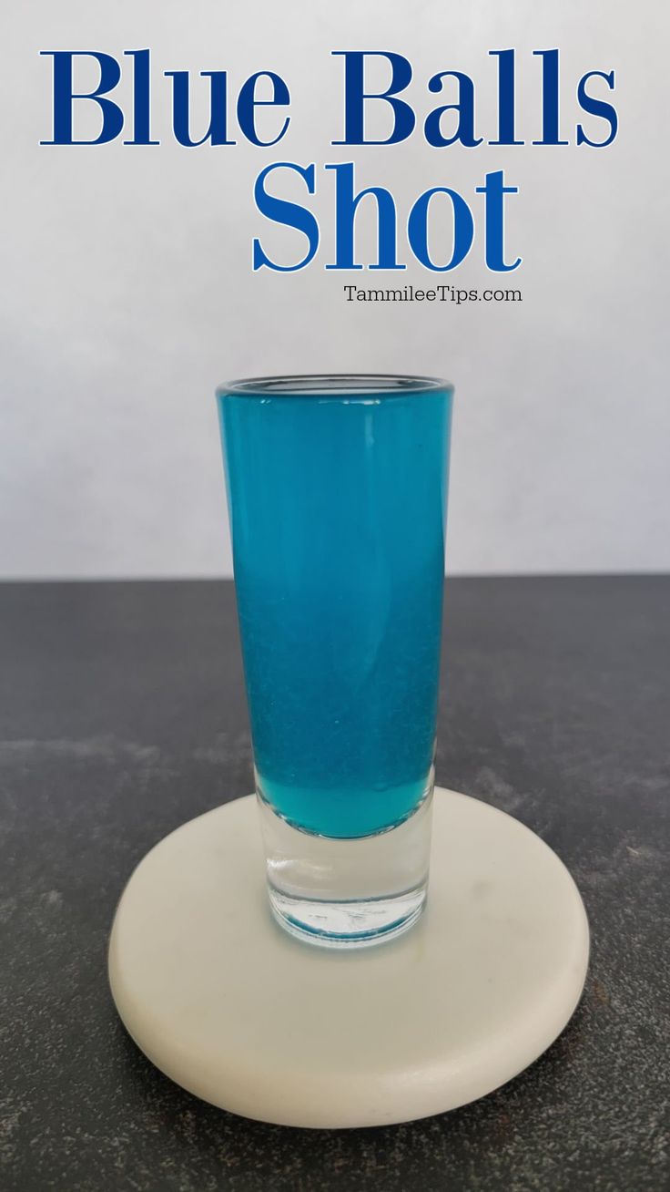 blue balls shot in a glass on top of a white plate with the words blue balls shot above it