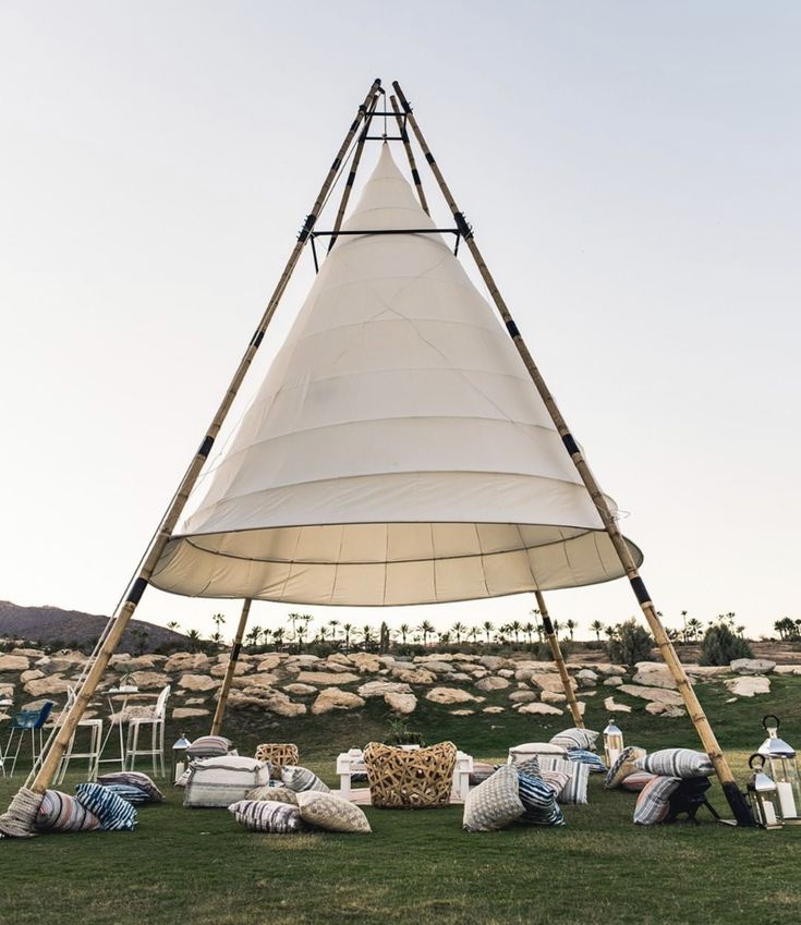 a large white tent sitting on top of a lush green field