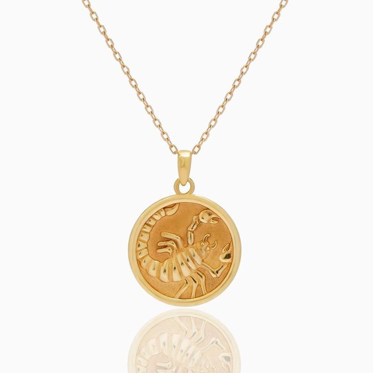 Scorpio Zodiac Coin Pendant - Classic. Crafted for you to flaunt your star sign, this necklace goes with every outfit and will give a hint of sentiment wrapped in luxury to your style. The Diamond Bezel around the Gold Coin blends into a delicate yet beautifully detailed piece. Coins 5. 4 grams of 18k yellow gold and 0. 44 ct natural diamonds Celestial Zodiac Sign Pendant Necklaces, Luxury Silver Zodiac Sign Necklace, Yellow Gold Zodiac Pendant Necklace, Celestial Zodiac Sign Pendant Necklace, Celestial Zodiac Pendant Necklace, 14k Gold Zodiac Sign Pendant Necklace, Elegant Zodiac Sign Medallion Necklaces, Elegant Zodiac Sign Medallion Necklace, Celestial Zodiac Sign 14k Gold Necklaces