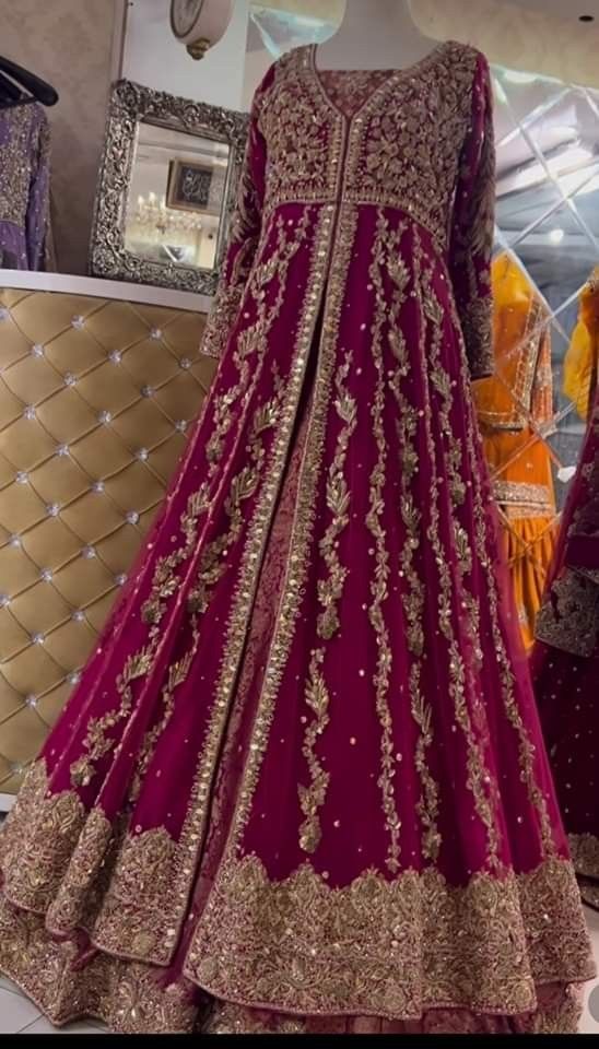 a red and gold wedding gown on display