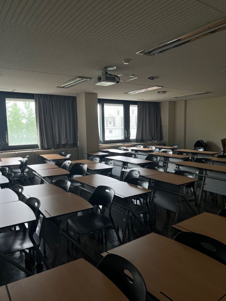 an empty classroom with desks and chairs