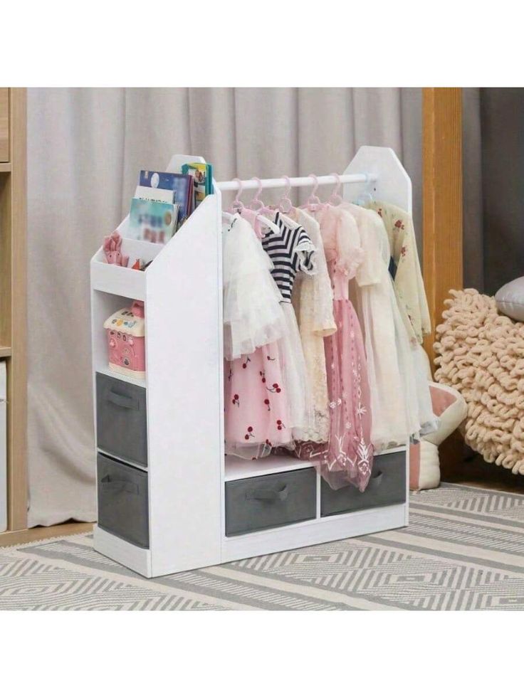 an organized closet with clothes hanging on the rack and two drawers in front of it