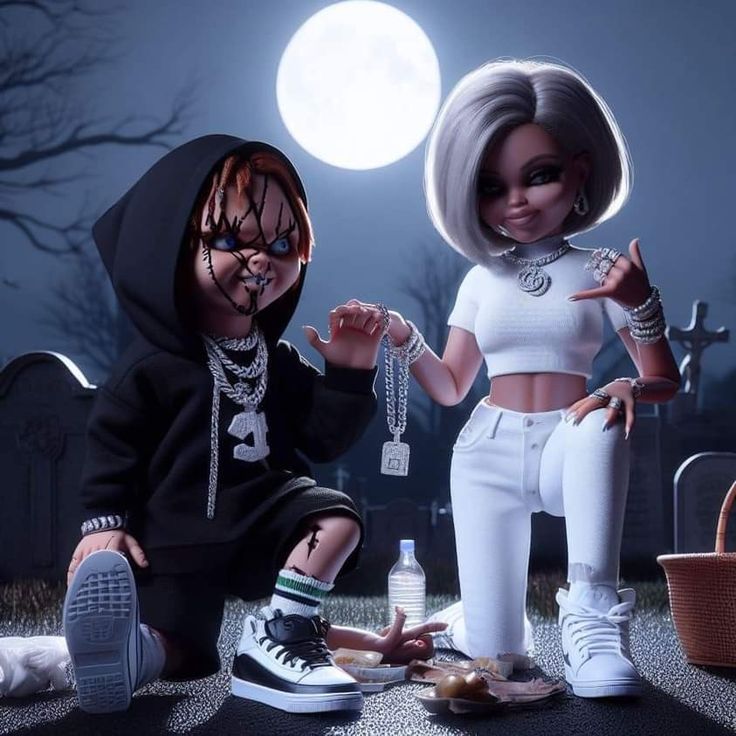 two dolls sitting on the ground in front of a full moon