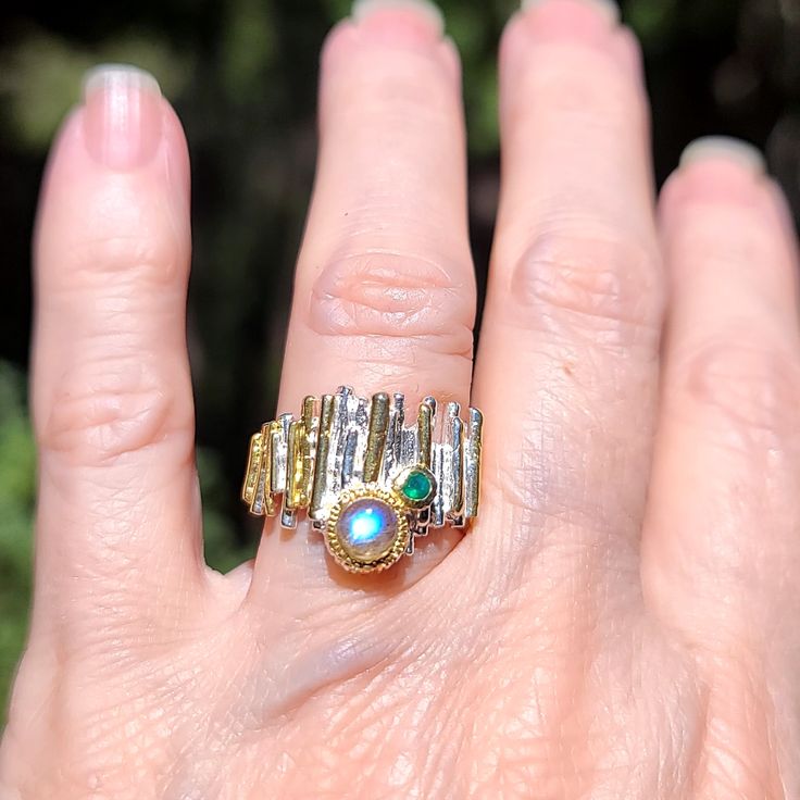 This Is A Unique Yet Beautiful New Statement Ring. A Stunning Labradorite Gem Sits Center Stage With One Little Green Onyx Accent Stone Set In Solid 925 Sterling Silver With 24k Gold Accents Built Up On The Fence Like Thick Band. This Is A Ring To Pass On As A Legacy Piece! Please Ask Questions And Make An Offer. I Can't Say Yes If You Don't Ask! Unique Multi-stone Opal Ring In Gold, Unique Gold Opal Ring With Multi-stone, Gold Fusion Rings With Gemstone Accents, Unique Gold Emerald Ring With Gemstone Accents, Unique Gold Opal Ring With Accent Stones, Gold Sterling Silver Multi-stone Emerald Ring, Fusion Style Opal Ring For Anniversary, Gold Opal Ring With Gemstone Accents For Anniversary, The Fence