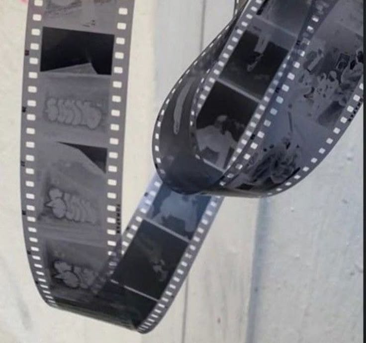 a film strip hanging from the side of a building