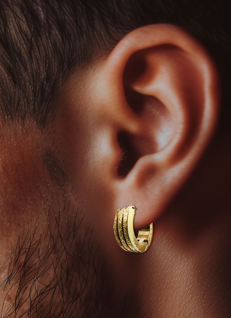 Men's Silver Huggie Earrings with a 12mm Gold Hoop: Elevate your style with our Men's Silver Huggie Earrings, featuring a sophisticated fusion of silver and gold. Crafted with meticulous attention to detail, these 12mm GoldHoop Earrings add a touch of refined elegance to any ensemble. Designed for the modern minimalist, these earrings boast a detailed patterned hoop that catches the eye without overwhelming your look. Whether you're dressing up for a special occasion or adding a subtle flair to Mens Gold Hoop Earrings, Mens Gold Earrings, Silver Huggie Earrings, Hoop Earrings For Men, Earrings Mens, Mens Earrings, Huggie Earrings Silver, Mens Earrings Hoop, Earrings For Men