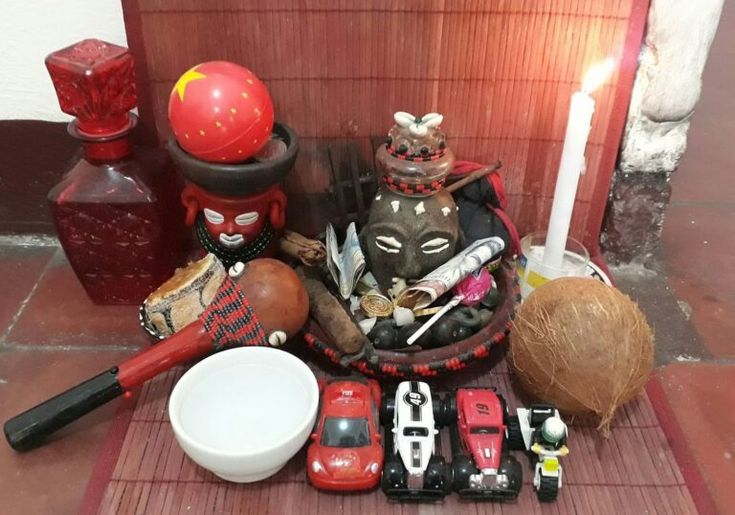 there are many items on the table including candles, figurines and other things