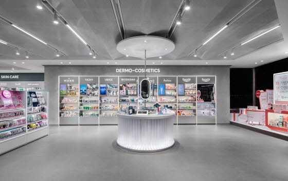 the inside of a cosmetics store with various products on display and in front of it is a circular counter