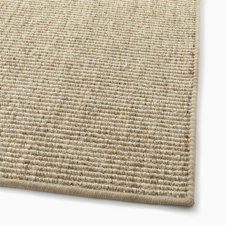 a close up view of a beige rug