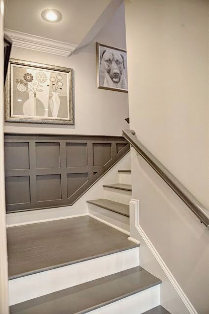 there is a staircase leading up to the second floor with pictures on the wall above it