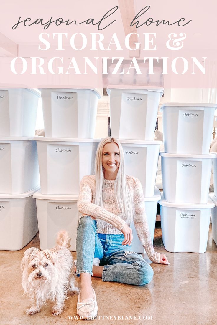 a woman sitting on the floor with her dog in front of stacks of storage bins