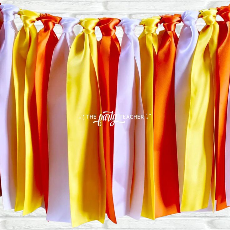 orange, white and yellow streamers are hanging from the wall