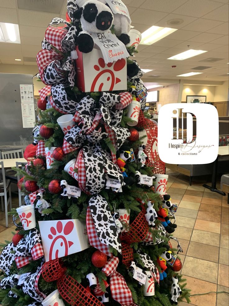 a decorated christmas tree in an office cubicle with gifts and decorations on the top