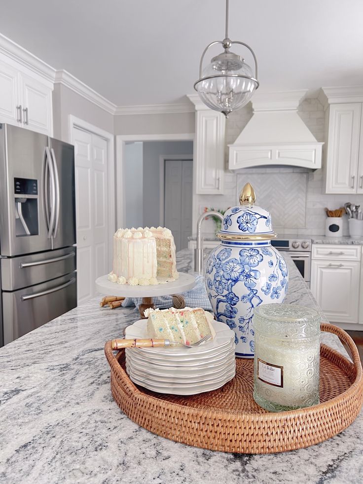 a kitchen counter with plates and cakes on it