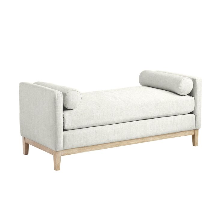 a white couch sitting on top of a wooden frame