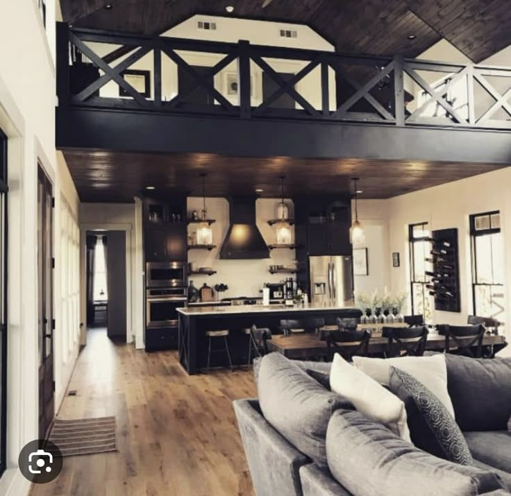 a living room filled with furniture next to a kitchen and an open concept floor plan