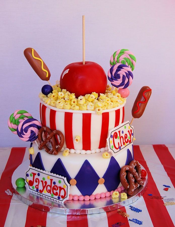 there is a large cake with candy and candies on the top, including an apple