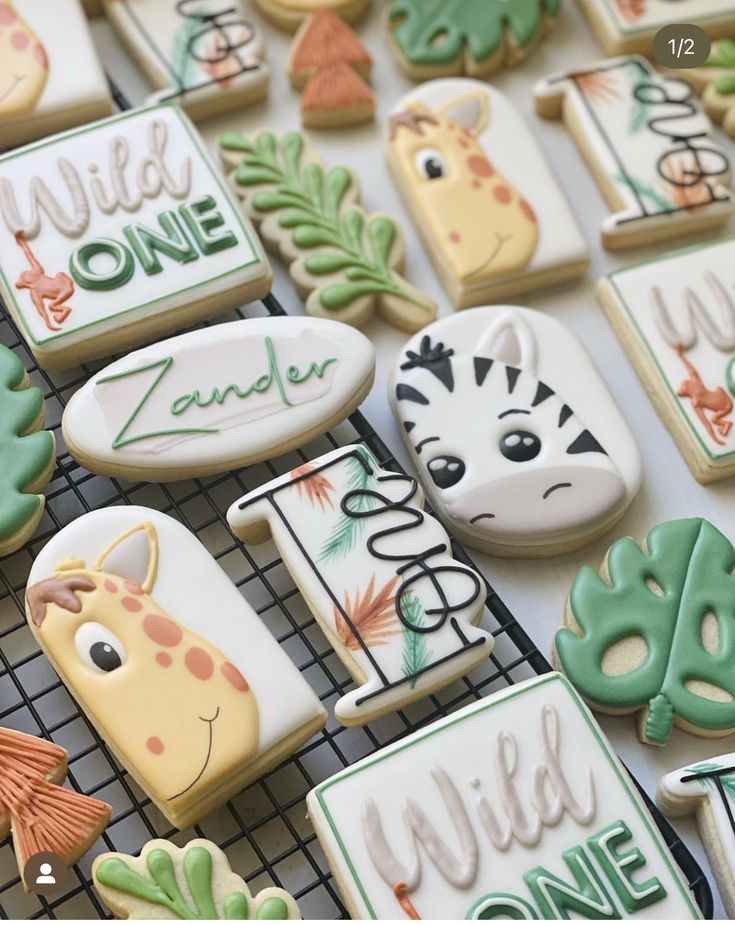 decorated cookies are displayed on a cooling rack