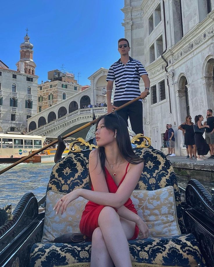 a woman sitting on top of a couch next to a man in a gondola